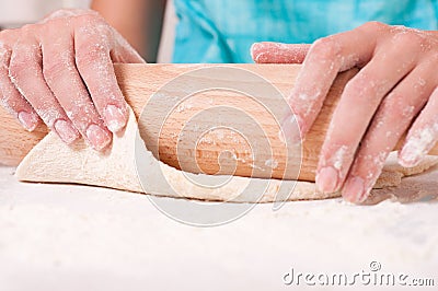 Woman hands mixing dough on the table Stock Photo