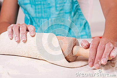 Woman hands mixing dough on the table Stock Photo