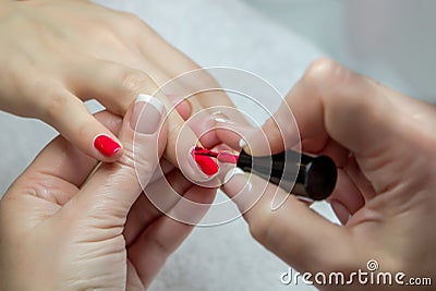 Woman hands in a nail salon receiving a manicure by a beautician Stock Photo