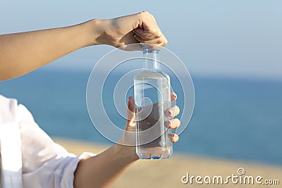 Woman hands opening a bottle of water outdoors Stock Photo