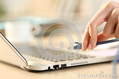 Woman hands plugging ethernet cable on laptop Stock Photo