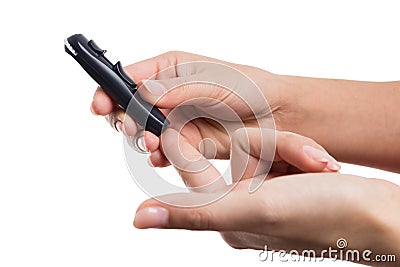 Woman hands poking finger to check glucose or blood sugar level Stock Photo