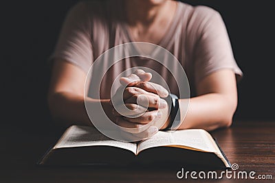 Woman hands praying to god with the bible. Woman pray for god blessing to wishing have a better life. begging for forgiveness and Stock Photo