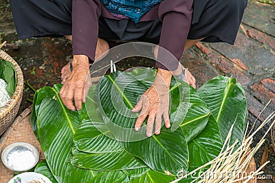 Woman hands preparing to make Chung Cake, the Vietnamese lunar new year Tet food Stock Photo