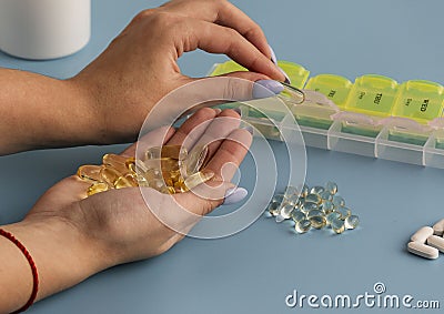Woman hands put pills in pill box. selective focus Stock Photo