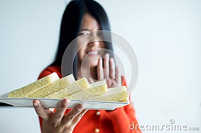 Woman hands refusing white bread,Female having allergy to bread,Food intolerance defined concept Stock Photo