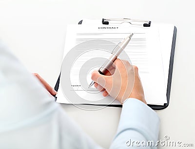 Woman hands signing a contract, isolated on desk Stock Photo