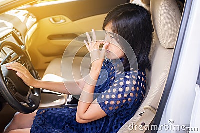 Woman hand squeeze her nose with of bad smell in a car Stock Photo