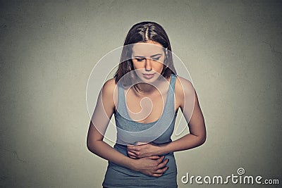 Woman hands on stomach having bad aches pain Stock Photo