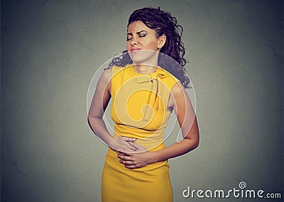 Woman with hands on stomach having bad aches pain Stock Photo