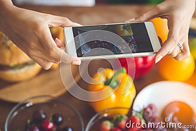 Woman hands taking photo fruit with smartphone, lifestyle concept. Stock Photo