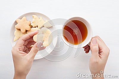Woman hands with tea cup and cookies Stock Photo