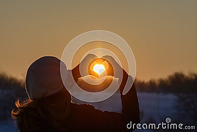 Woman hands in winter gloves. Heart symbol shaped, lifestyle and Stock Photo