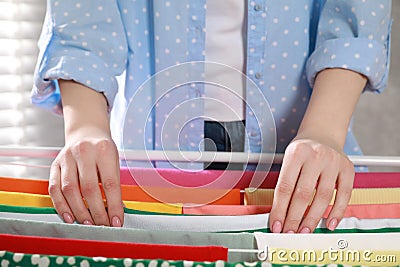 Woman hanging different apparel on clothes airer, closeup Stock Photo