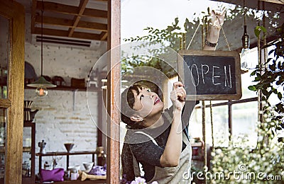 Woman hanging an open sign Stock Photo