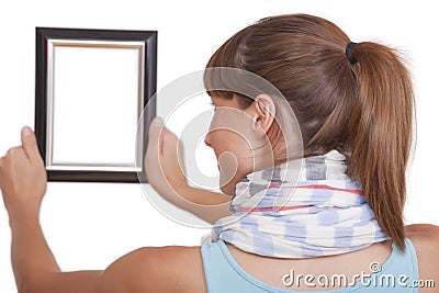 Woman hanging photo frame Stock Photo