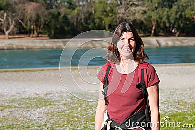 Woman happy middle aged cute smiling walking lake river sea side Stock Photo