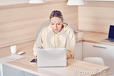A woman is happy after receiving a new order from a client, checking commercial offers, online marketing. The concept of Stock Photo