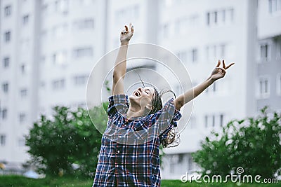 Woman happy smiling happiness hands outstretched toward the rain Stock Photo