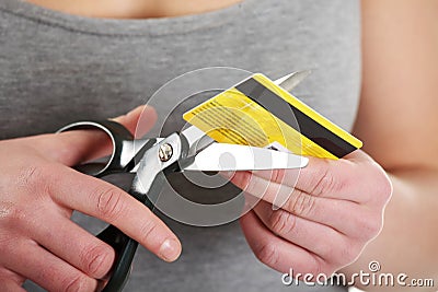 Woman has to destroy her credit card Stock Photo