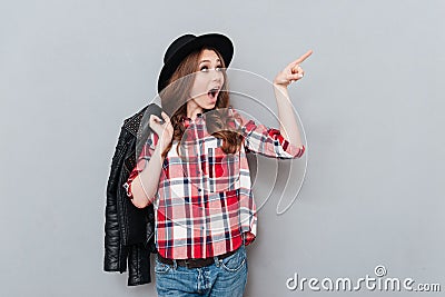 Woman in hat and plaid shirt pointing finger away Stock Photo