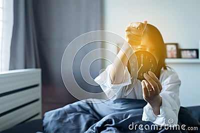 Woman hates getting stressed waking up early 7 o`clock in the morning,Alarm clock Stock Photo