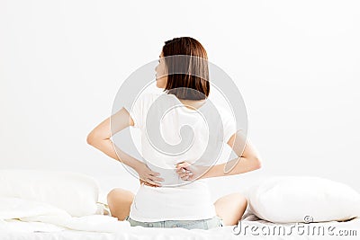 Woman have backache on white bed Stock Photo