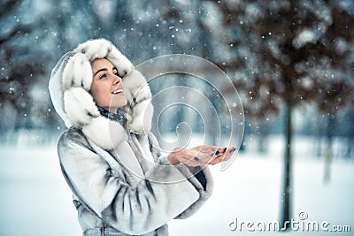 Woman have fun on the snow in winter forest Stock Photo