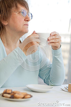 Woman having coffee with cookies Stock Photo