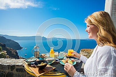 Woman having delicious breakfast in luxurious resort in Mediterranean Stock Photo