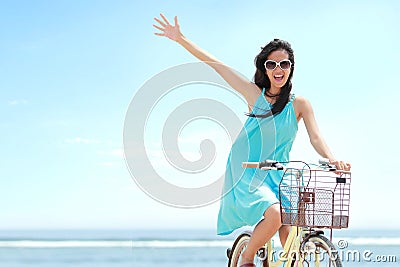 Woman having fun riding bicycle at the beach Stock Photo