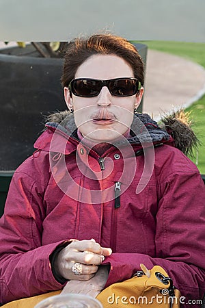 Woman having fun touching her nose with the tongue Stock Photo