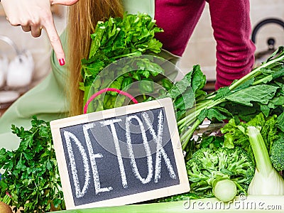 Woman having green diet vegetables, detox sign Stock Photo