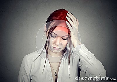 Woman having a headache with her head in her hand Stock Photo