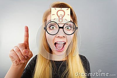 Woman having light bulb mark on forehead thinking Stock Photo