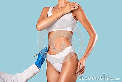 Woman having lipolysis treatment, doctor drawing with marker Stock Photo