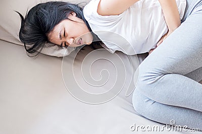 Woman having painful stomachache,Female suffering from abdominal pain Stock Photo