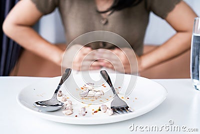 woman having peanut allergy reaction with digestive problems stomach cramps, nausea and diarrhea Stock Photo