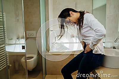 Woman having severe abdominal menstrual pain.Gastrointestinal autoimmune disease.Dysmenorrhea/endometriosis.Gastrointestinal Stock Photo