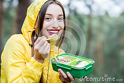 Woman having a snack in the forest Stock Photo