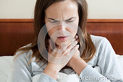 Woman having a sore throat Stock Photo