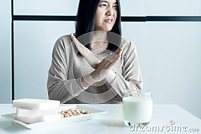 Woman having a stomach pain with a glass of milk at home,Allergy dairy intolerant,Lactose intolerance concept Stock Photo