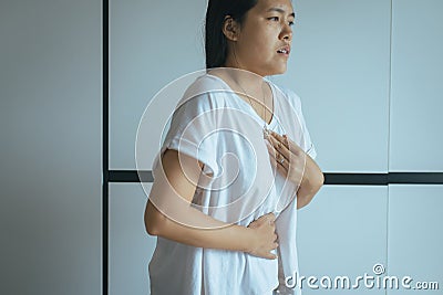 Woman having or symptomatic reflux acids,Gastroesophageal reflux disease,Because the esophageal sphincter that separates the esoph Stock Photo