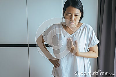 Woman having or symptomatic reflux acids,Gastroesophageal reflux disease Stock Photo