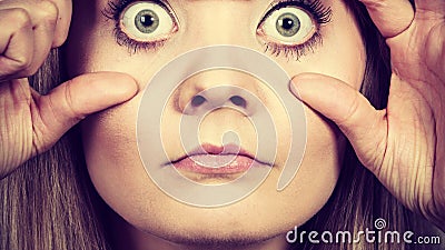Woman having weirdly wide open eyes Stock Photo