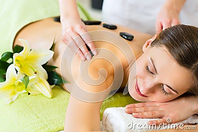 Woman having wellness hot stone massage Stock Photo