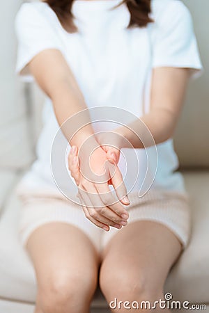 Woman having wrist pain at home, muscle ache due to De Quervain s tenosynovitis, ergonomic, Carpal Tunnel Syndrome or Office Stock Photo