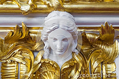 Woman head antique sculpture on gold wall Stock Photo