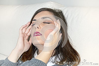 Woman with headache with hands on her head Stock Photo