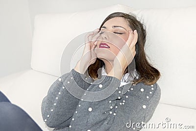 Woman with headache with hands on her head Stock Photo